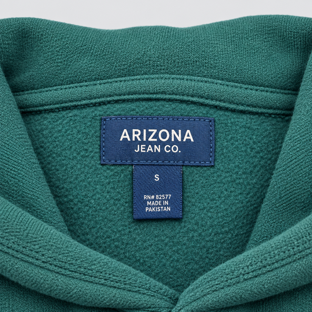 Label close-up of Arizona Jean Co. hoodie on light gray background