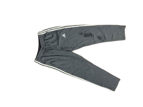 Adidas dark gray jogger pants with white 3-stripe detail, white background